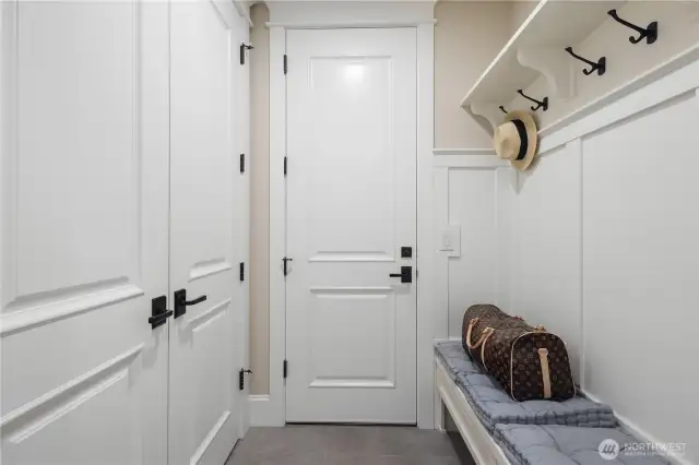 The mudroom, conveniently located off the garage, is the perfect space for organizing and keeping things tidy.