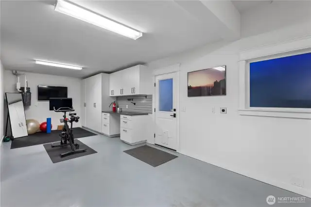 The fully finished and insulated 3-car garage is a standout, featuring epoxy floors, custom storage solutions, a slot wall, and a workbench. Plus, it’s equipped with an EV charger for added convenience.