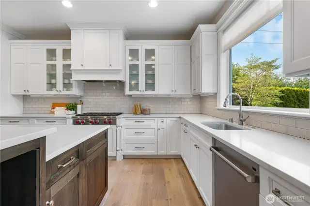 With its timeless finishes, this kitchen is designed to stand the test of time. A large picture window frames stunning views of the downtown skyline and the private backyard.
