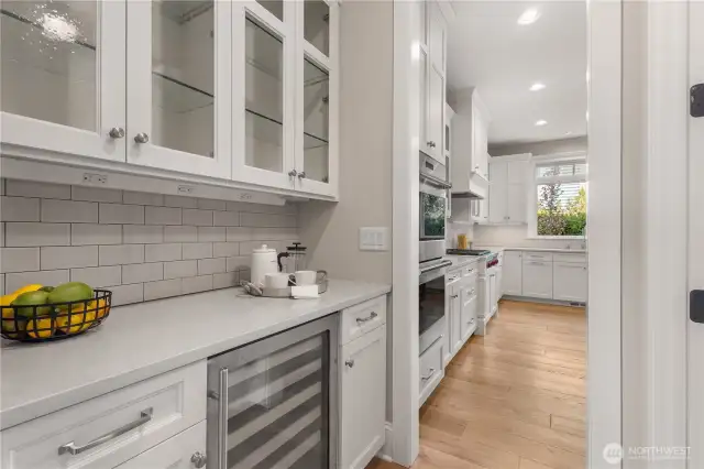 The butler’s pantry includes a wine fridge and provides the perfect spot to tuck away dishes and prep discreetly while entertaining.