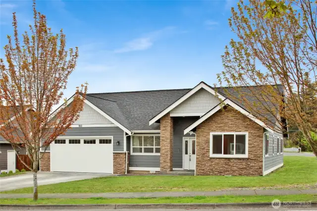 Welcome Home to 910 Maple Ridge Dr. Great curb appeal on a corner lot with stone details and covered front porch entry.