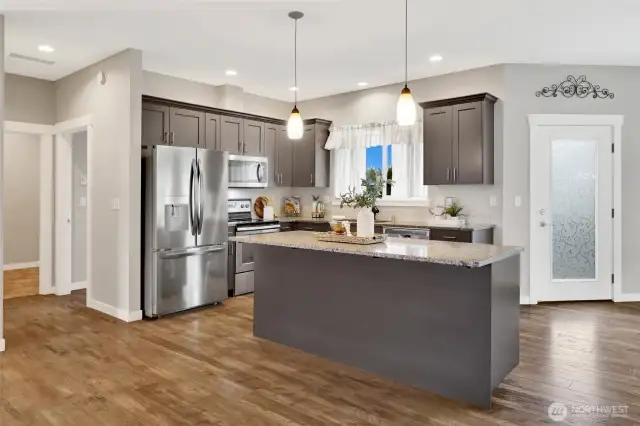 Great kitchen that is open to the living area is wonderful for entertaining, the door off the kitchen heads out to the patio for barbecuing and outdoor dining, and the large backyard.