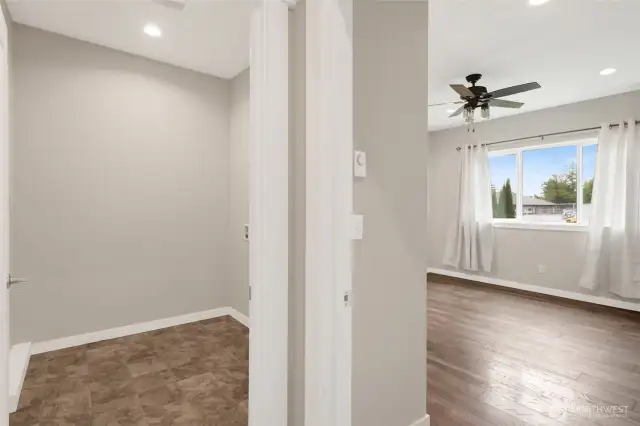 Hallway leads to the laundry room to the left and the primary bedroom to the right. The primary bedroom faces the backyard.