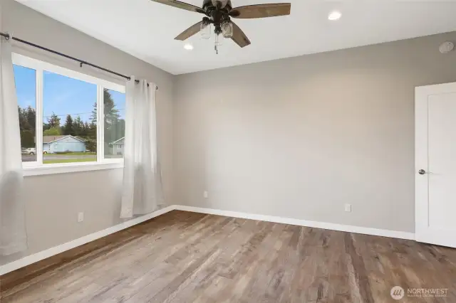 Primary bedroom looks onto the backyard, and walk-in closet, and ensuite full bath.