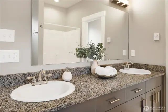 Granite countertops and dual vanity.
