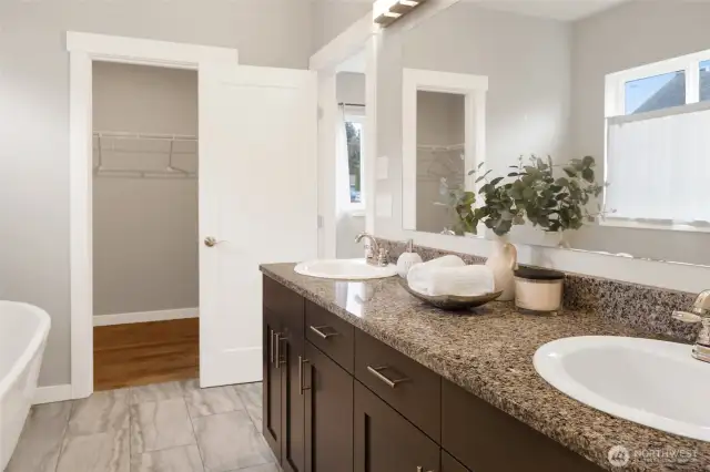 Primary bath with a large walk-in closet.