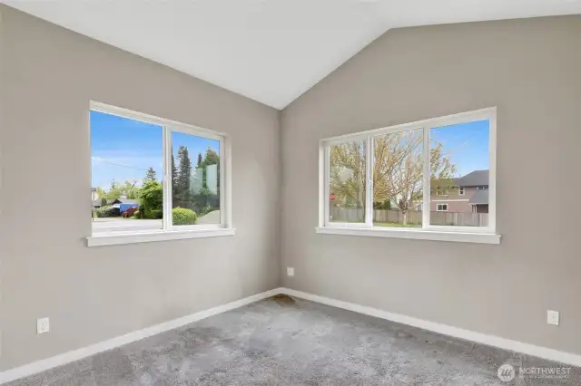 Second bedroom with vaulted ceiling and faces the front yard. There is LVP flooring in the garage for new owners to install is the same flooring in the third bedroom that was just installed.