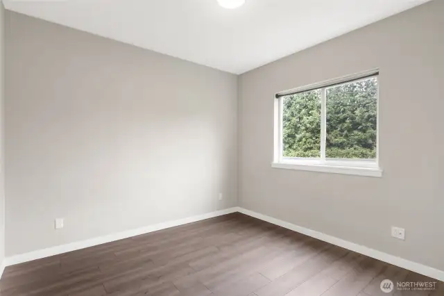 Third bedroom with newly installed LVP flooring for easy care, and this faces the side yard and street.