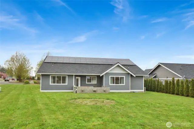 Large backyard and view of the home with solar panels.