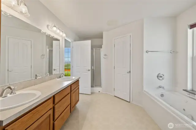 Full bath with a walk in shower and deep tub.