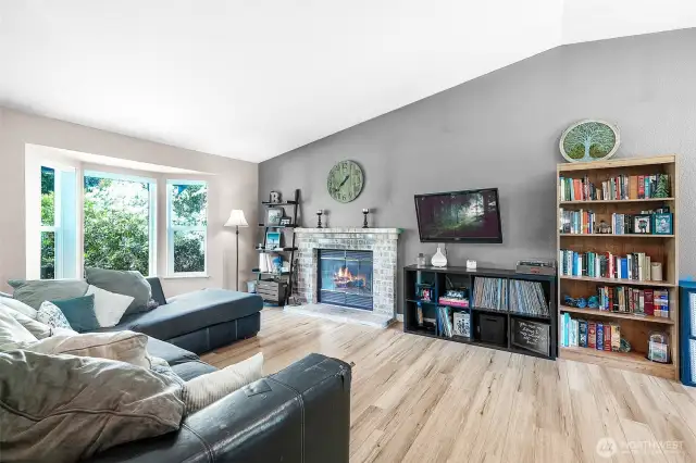 Bright and open familyroom with woodburning fireplace.