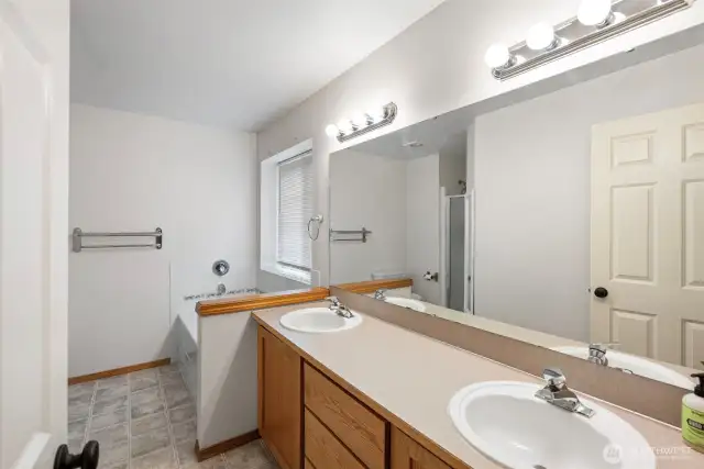The 5 piece ensuite features a large soaking tub and separate shower