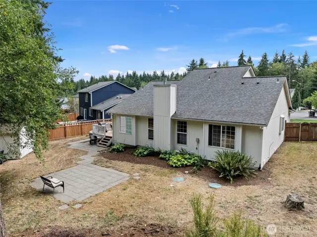 The backyard features different entertaining areas:  private deck, paved patio and large firepit area!