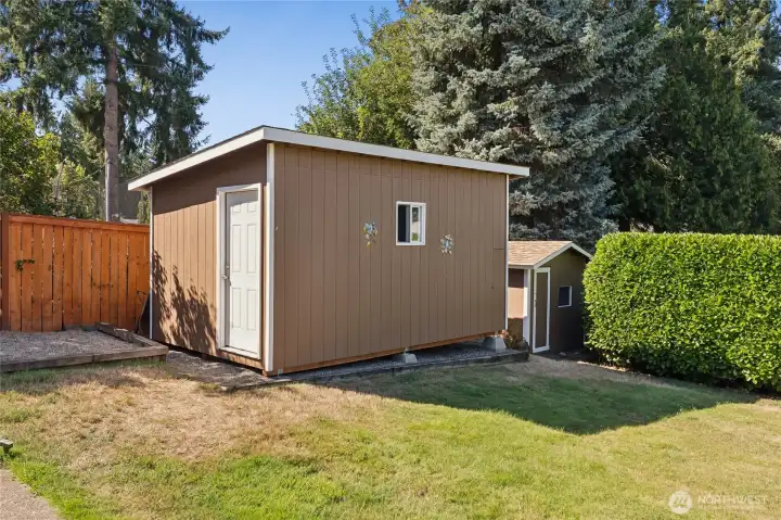 Two storage sheds in back yard.