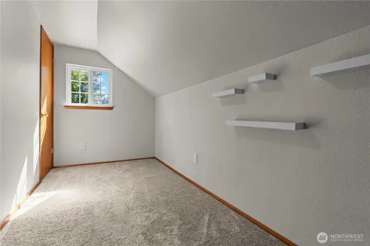Fourth bedroom space with floating shelving.