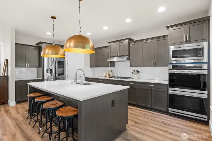 Cooking enthusiasts will love the double ovens and generous counter space in this beautiful kitchen—ideal for preparing everything from weeknight dinners to elegant three-course meals. The walk in pantry will keep all your cooking essential organized and at hand.