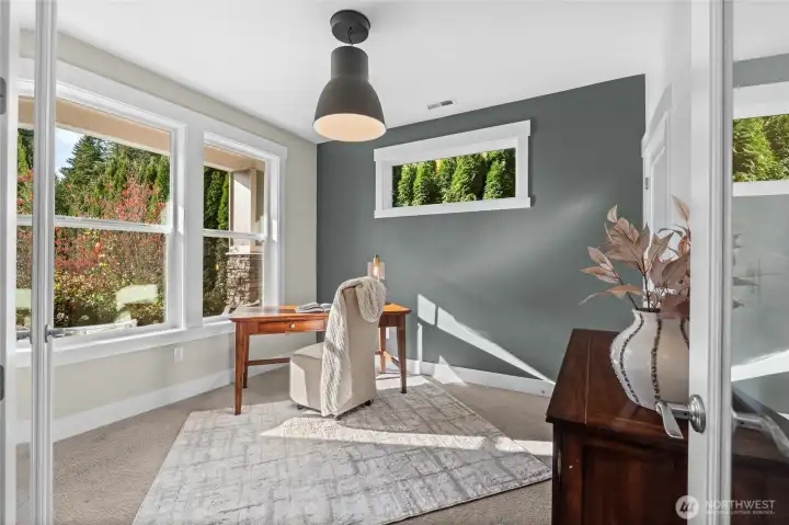 A large office, bathed in natural light and with views of the front yard offers a beautiful place to call your work space