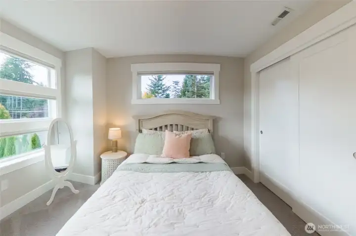 The third guest bedroom includes ample closet space.