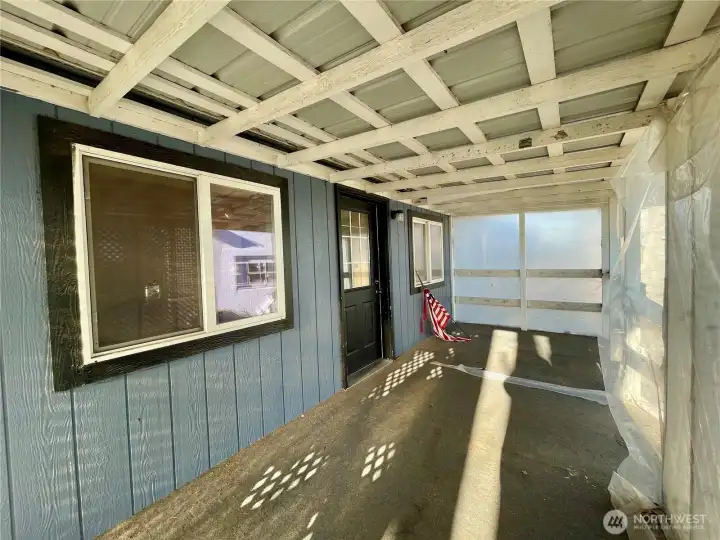 Covered porch by back entry.