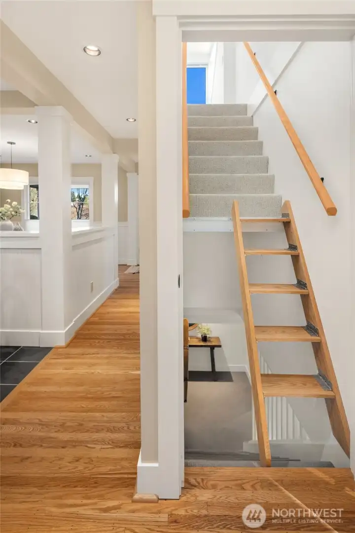 Ship's Ladder steps to Architect Loft are hinged and fold up to the wall to the right for more open access to the Lower Level.