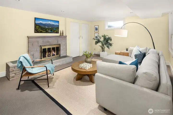 Lower Level - 3rd conforming bedroom with wood burning fireplace staged as rec room