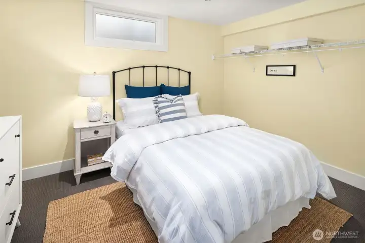 Lower level bonus room staged as non-conforming bedroom but has many uses  .