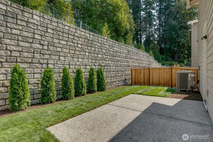 Example of the fully fenced and landscaped backyard with patio offering maximum privacy. Photo taken from another house.
