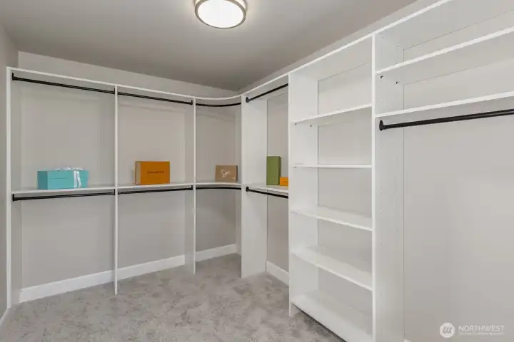 Extra-large Primary walk-in closet with custom organizing system.