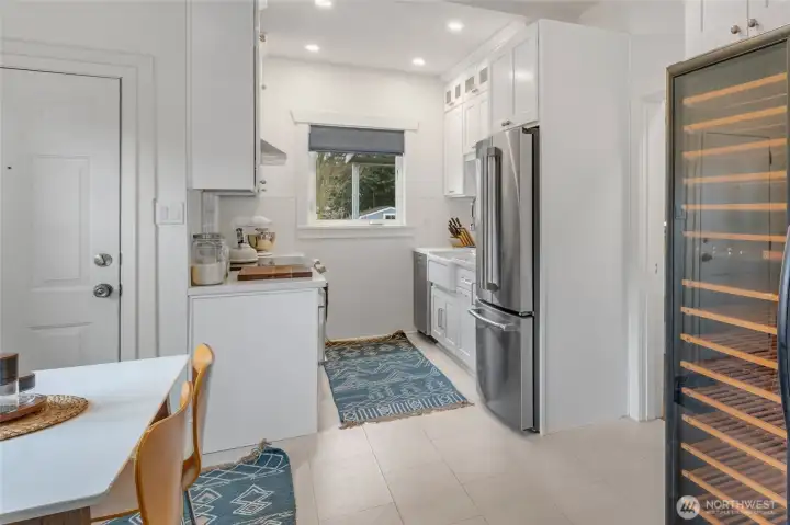 Updated kitchen includes space for an extensive wine collection...