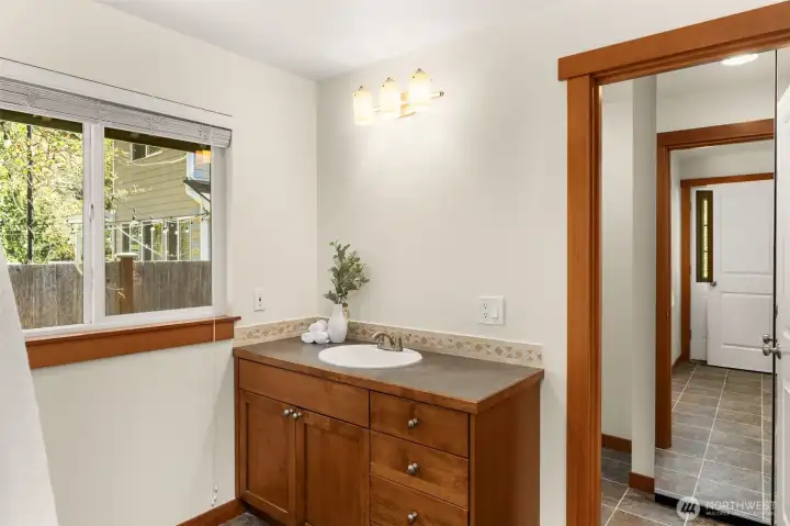 One of two bathrooms on the main level. This is a 3/4 bath that has a door out to the backyard.