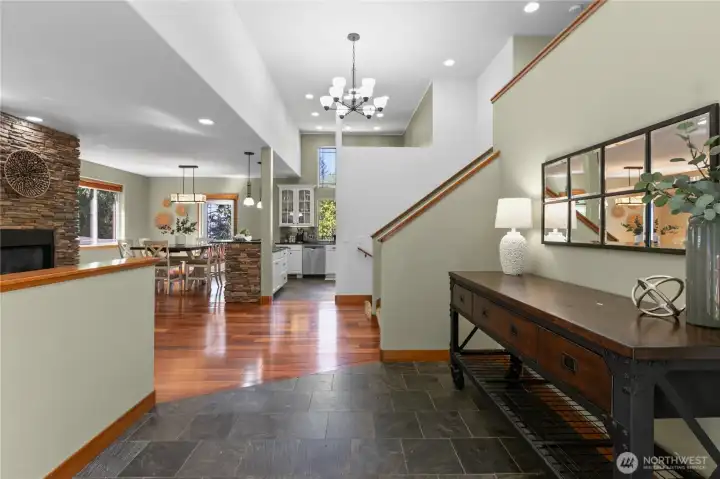 Spacious entryway with slate tile flooring, high ceilings, and sightlines into the main living areas.