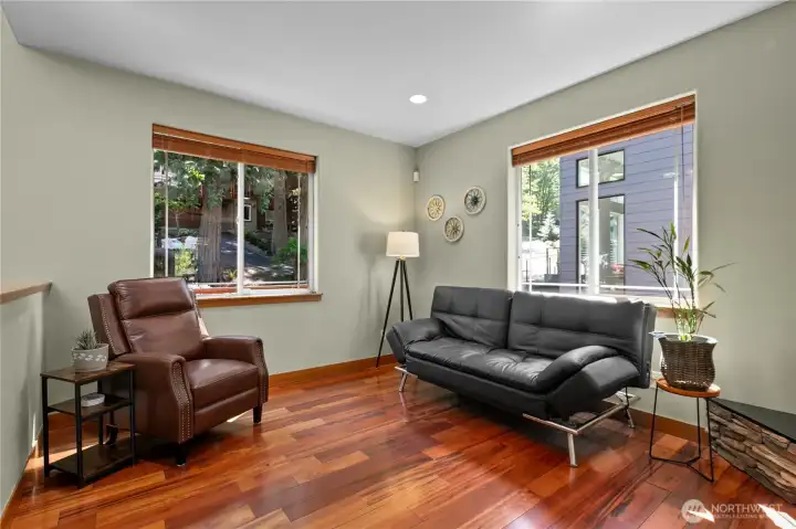 Light-filled sitting area with oversized windows and flexible space for reading, conversation, or everyday living.