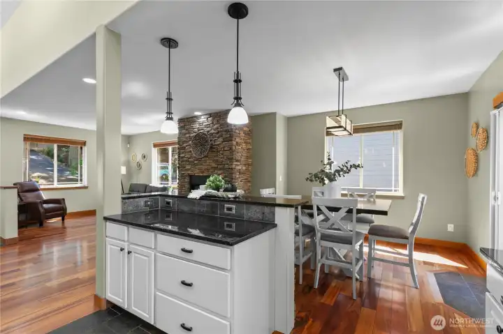 Oversized island and open dining area create a natural gathering space at the center of the home.