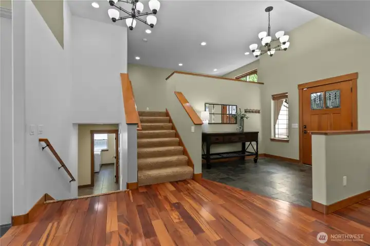 Split-level entry design with wide stairways, vaulted ceilings, and open sightlines throughout the home.