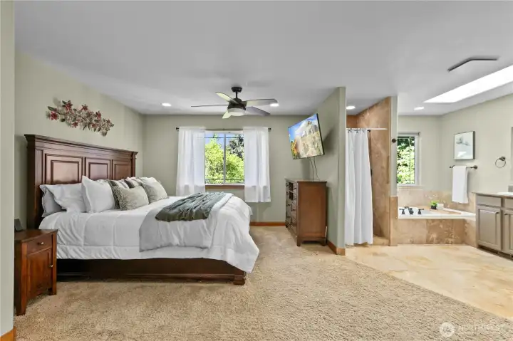 Spacious primary suite with room for a sitting area and direct access to the spa-inspired ensuite bath.