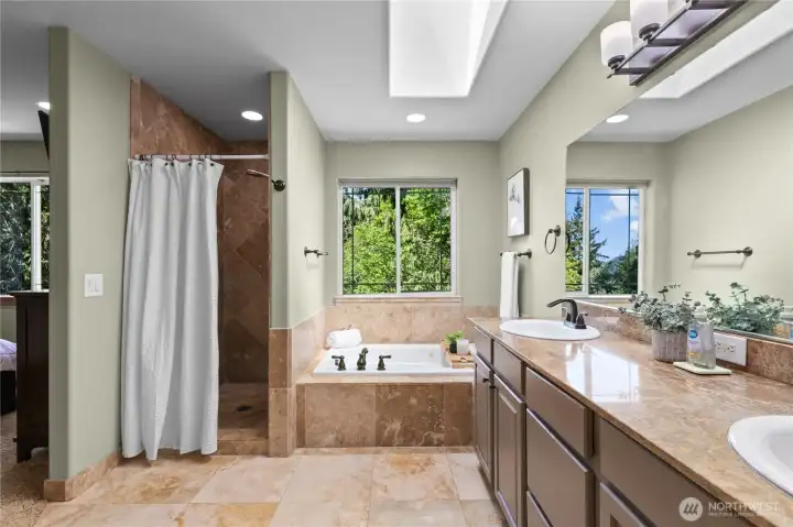 Generous ensuite bath featuring dual sinks, abundant counter space, and calming natural light.