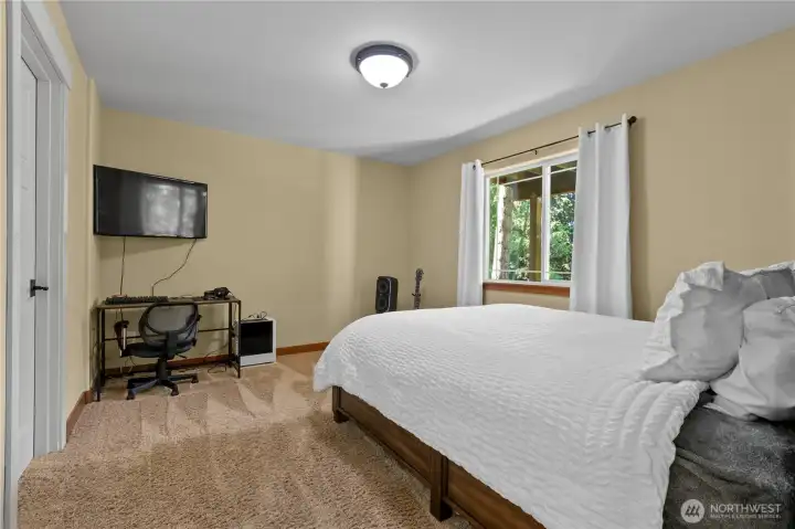 Bright secondary bedroom with updated flooring and ample space for guests, hobbies, or workspace needs.