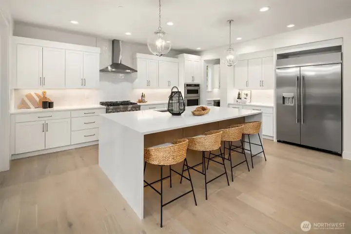 Kitchen-Aid large capacity, counter depth refrigerator and soft close cabinets.