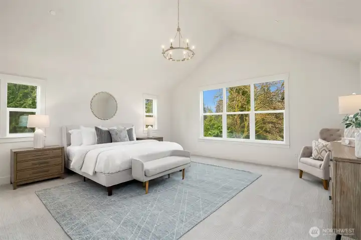 Stunning, oversized primary suite with vaulted ceilings.