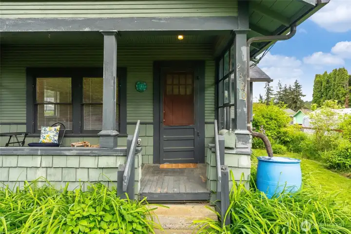 Welcoming covered front porch, partially inclosed