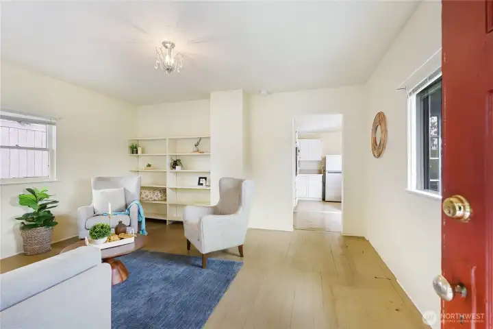 Bright and warm entry room, featuring built in bookshelf