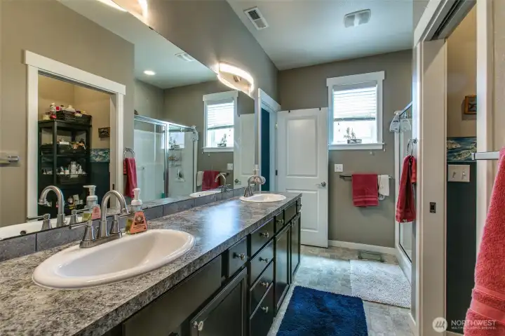 Double vanity, and large shower cubicle in primary bathroom Double vanity, and large shower cubicle in primary bathroom