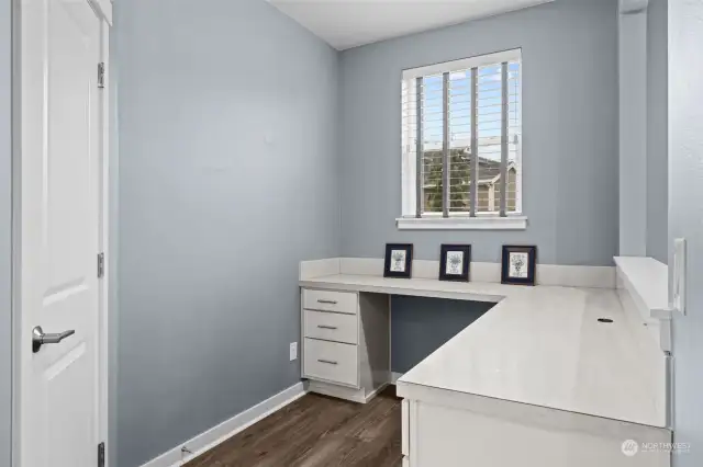 EXTRA BONUS!! A second desk space - work area! The door on the left is a walk-in pantry conveniently located next to the kitchen.