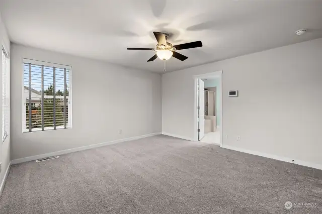 This Spacious Primary Bedroom has plenty of light with several large windows. The Ceiling Fan offers comfort all year long. The Primary Bathroom is located off of the Primary Bedroom.