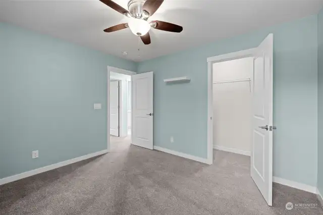 Bedroom #4 with a walk-in closet and ceiling fan.