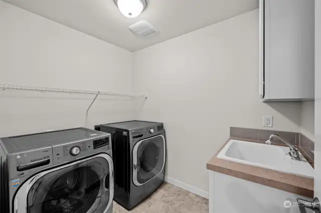 The Laundry Room is perfectly located on the 2nd floor with the bedrooms. LG Extra Large Washer and Dryer stay with the home! A utility tub, cabinets and shelving provide a great space to help keep everything organized.