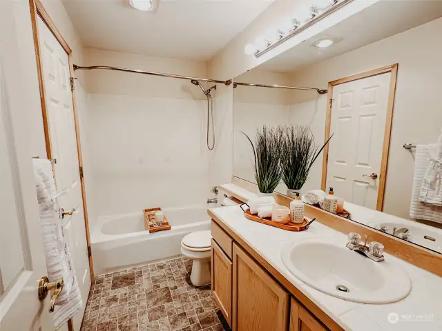 En-suite bathroom boasts a combination of function and luxury, highlighted by a full-size bathtub for a tranquil retreat