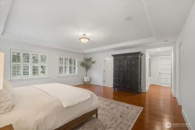 Primary Suite also features large window with wood shutters.