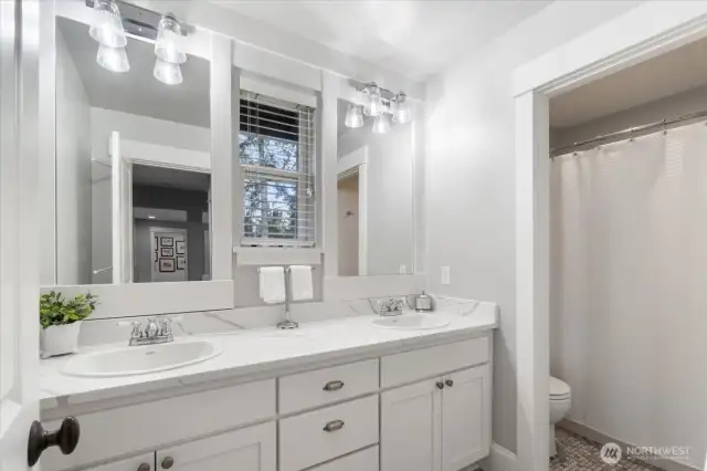 Upper Guest Bath features bathtub and marble flooring.