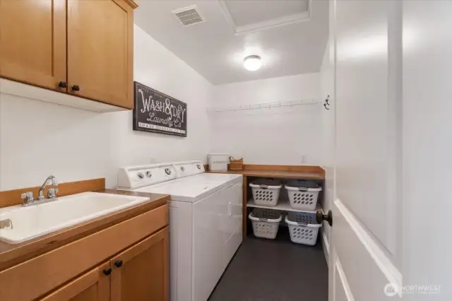 Laundry room is located in upper floor for your convenience. It feature a utility sink and wood cabinetry. Washer and Dryer do not convey with property.